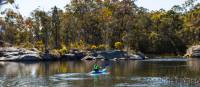 Woman enjoying an afternoon kayak through Ganguddy (Dunns Swamp) in Wollemi National Park