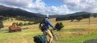 Cyclist taking in the beautiful rural scenes on Myrtle Mountain Road | Kate Baker