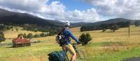 Cyclist taking in the beautiful rural scenes on Myrtle Mountain Road | Kate Baker