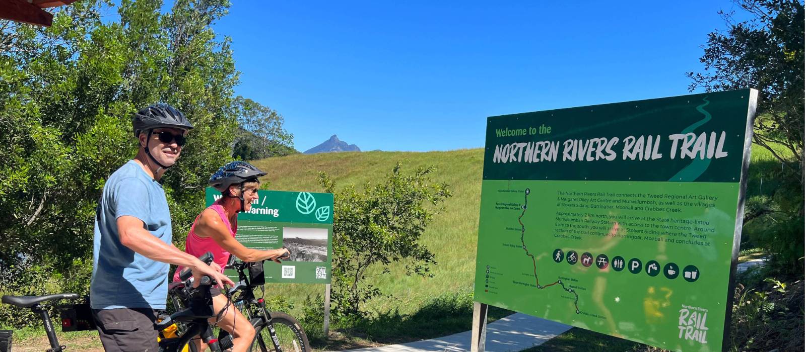 Couple on rail trail viewing Wollumbin | Kate Baker