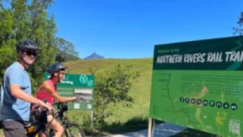 Couple on rail trail viewing Wollumbin | Kate Baker