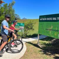 Couple on rail trail viewing Wollumbin | Kate Baker