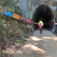 Cyclist entering tunnel on the northern rivers rail trail | Kate Baker