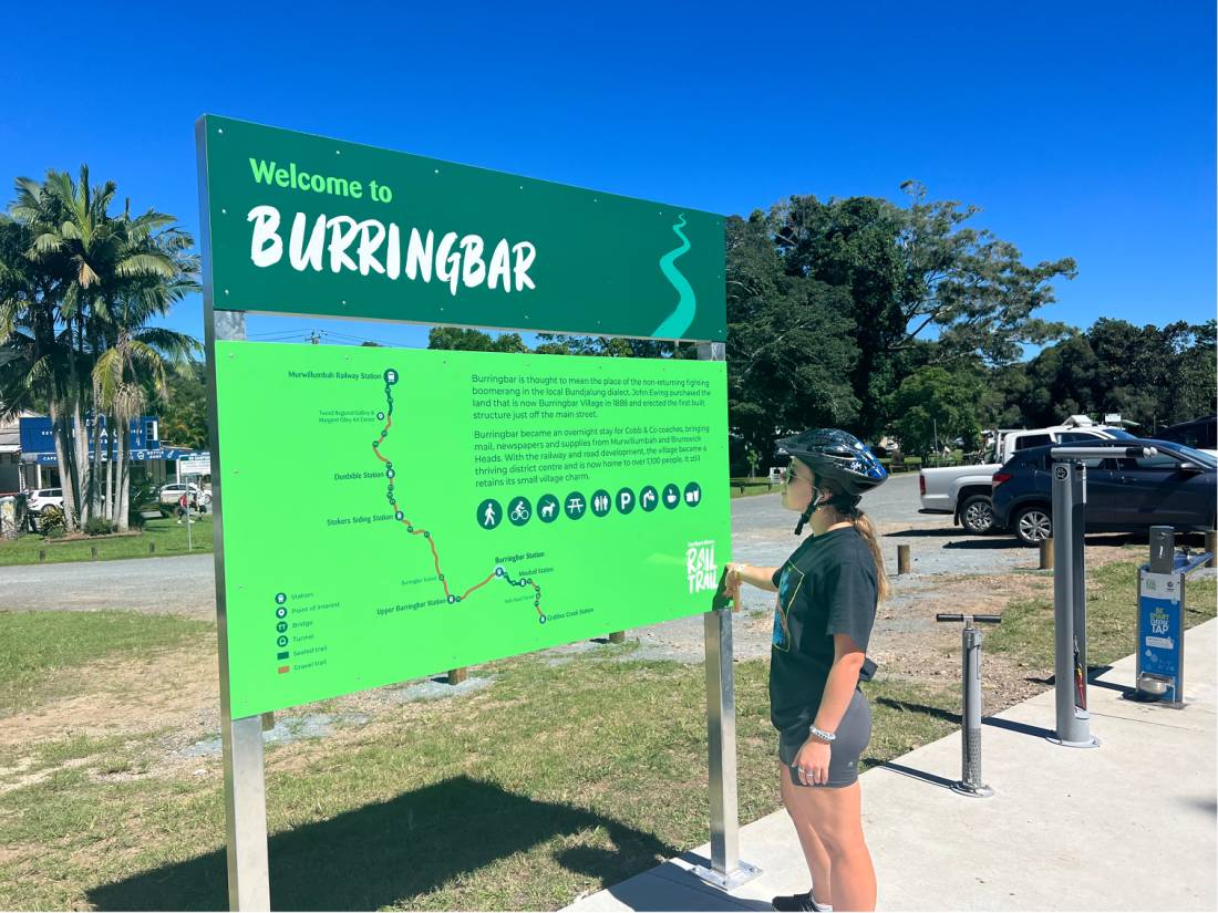 Cyclist looking at signage on the Northern Rivers Rail Trail |  <i>Kate Baker</i>