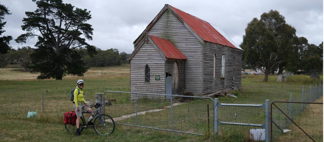 Cyclist viewing a rural church enroute to Wyndham | <i>Ross Baker</i>