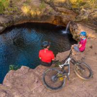 Cycling rest stop by a waterfall in the Top End. | Travis Deane