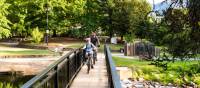 Cycling over the Ovens River bridge near Bright | Ride High Country