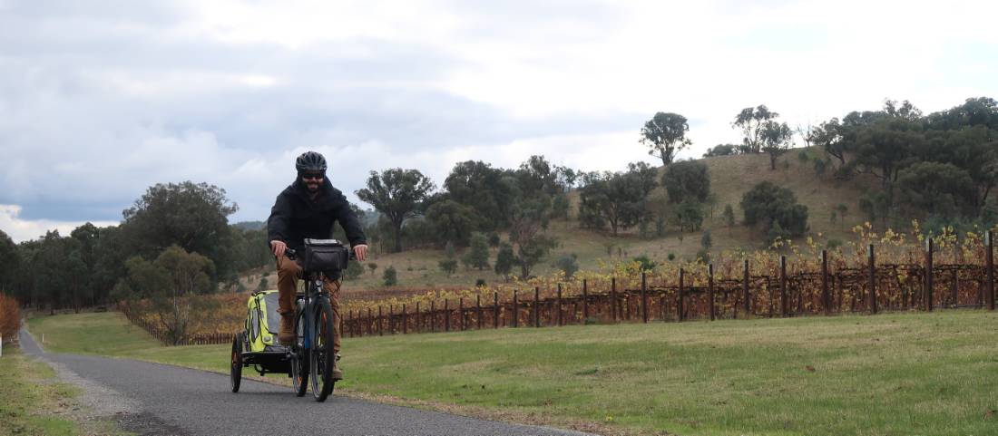 Cycling past a winery on the Murray to Mountains Rail Trail |  <i>Erin Williams</i>