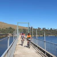 Cyclists on the Bonnie Doon Bridge over Lake Eildon | Rail Trails Australia