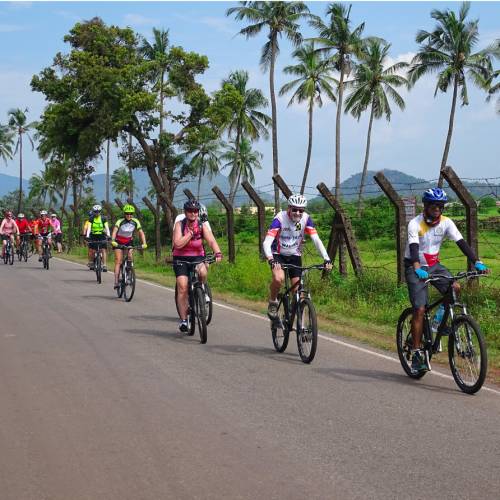 Happy cyclists on a quiet road in Karnataka, India