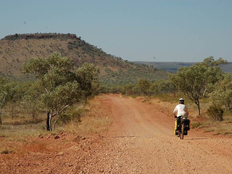 Kate cycles the Buchanan Highway on the way to Victoria River Downs Station |  <i>Kate Leeming</i>