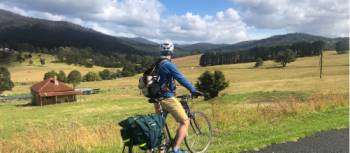 Cyclist taking in the beautiful rural scenes on Myrtle Mountain Road | Kate Baker