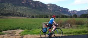 Cyclist passing the impressive escarpment of the Capertee Valley | Ross Baker